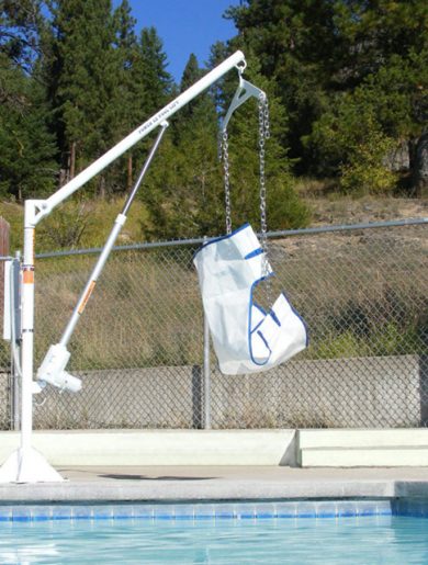 ez 2 pool lift on the edge of the pool, with sling seat and chains.